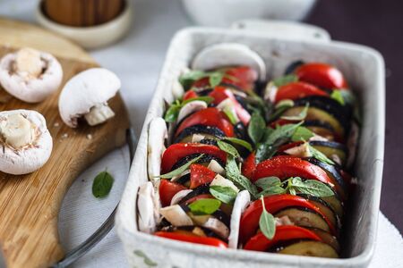 Parmigiano eggplant - a dish of Italian cuisine, vegetarian casserole with eggplant, basil, mushrooms, tomatoes and cheeseの写真素材
