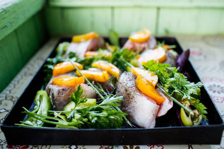 Homemade zander fish with vegetables and herbs
