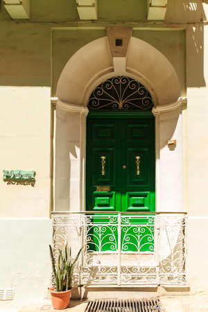 beautiful green entrance door with a low lace lattice in front of the stepsの写真素材