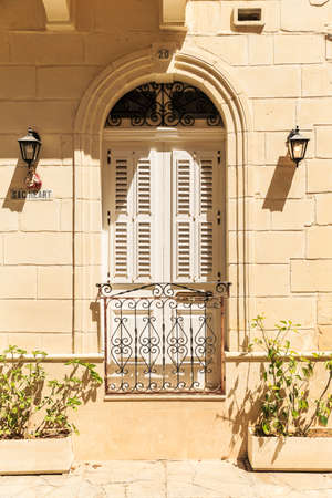 mediterranean closed white louvered French balcony doors with lace latticeの写真素材