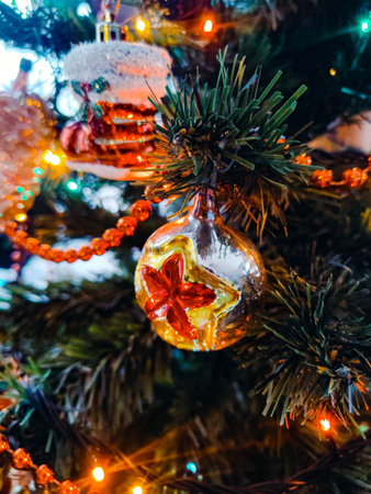 Christmas tree with silver and gold decoration, red star, red beads and other decorations in the background. New yearの写真素材