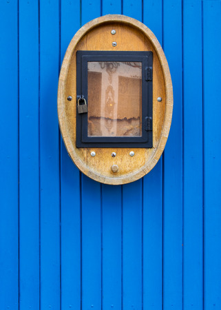 The ancient wooden door painted blue color with the vintage ornament located from outer sideの写真素材