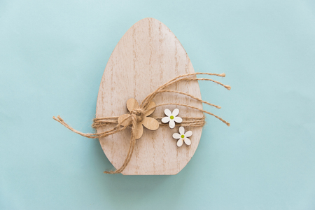 Easter wood handmade egg on the blue background. Easter concept.の写真素材