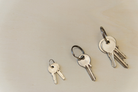 Three iron keys on the wood background. Copy space. Flat lay.の写真素材