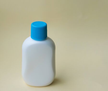 White plastic bottle for cream or oil on the yellow background. Copyspace. Space for text.の写真素材