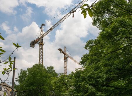 Metal yellow building crane outside in summer sunny day.の写真素材