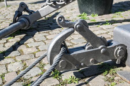 Fastening for anchor of the ship on a embankment in a port, near a river.の写真素材