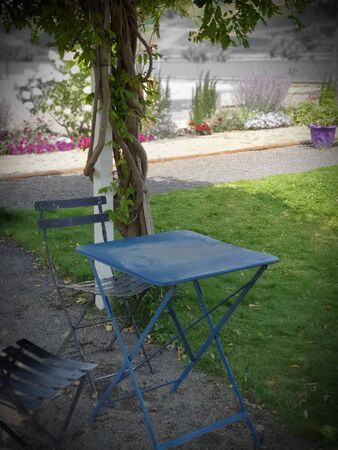 Place for relaxing in park with panoramic view. Table and chairs for family near the river.の写真素材