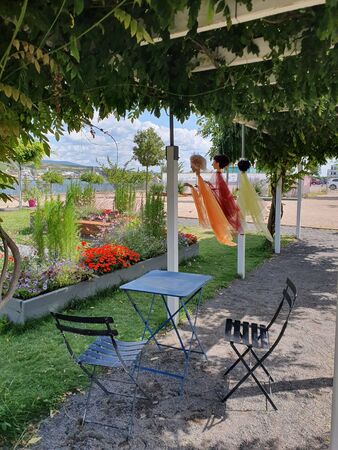 Metal table and chairs for family near the river. Place for summer relaxing in park with panoramic view.の写真素材