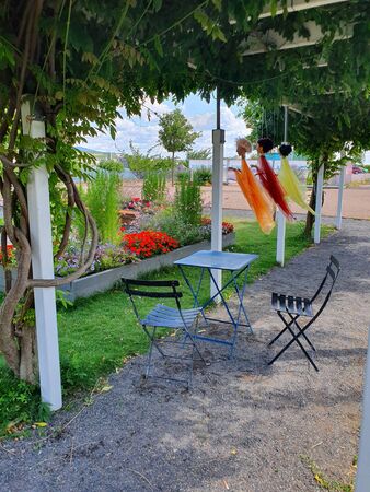 Iron table and chairs for family near the river. Place for summer relaxing in park with panoramic view.の写真素材