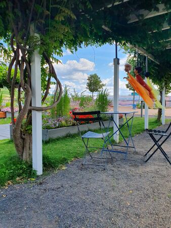 Metal table and chairs for summer rest near the river. Park with panoramic view.の写真素材