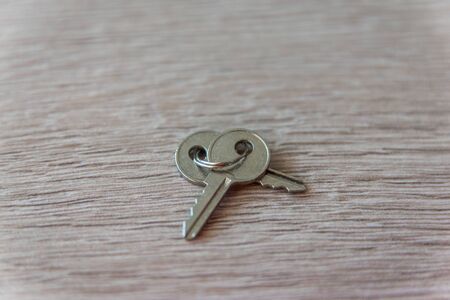 Two old iron keys on the wood table background. Copy space. Flat lay.の写真素材