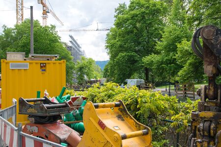 Demolition of building, crane, yellow container and nature in the city. Reinforced concrete structures.の写真素材