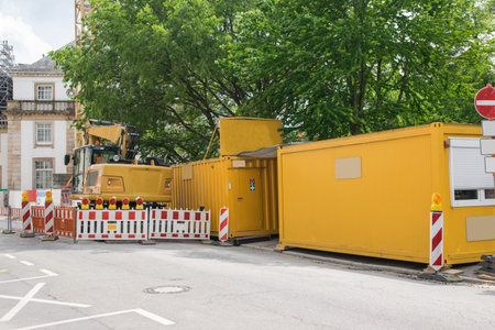 Repair and reconstruction of building, crane, yellow container and nature in the city. Reinforced...