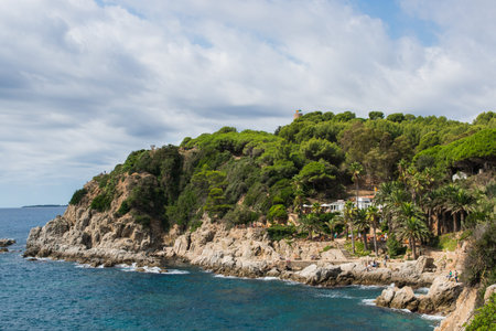 Hotel on the island with palm trees, cafe, people on the sea coast. Panoramic aerial view of the...