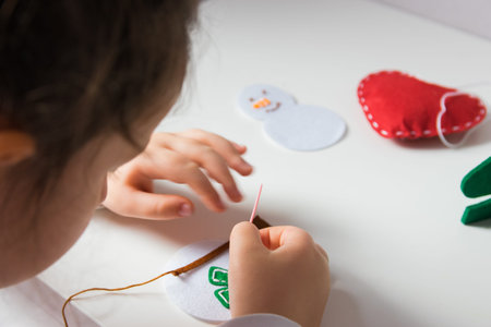 The hand of the child make snowman for Christmas greeting card. Xmas toys decoration for greeting...