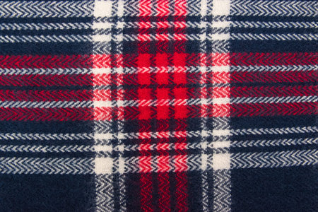 Winter cashmere scarf. Blue, white, red cage texture fabric. Textile warm dark knitted cloth...