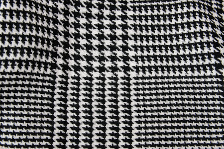 Winter cashmere scarf. Black and white cage texture fabric. Textile warm dark knitted cloth...