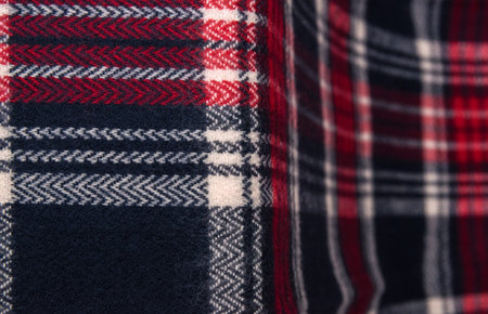 Winter cashmere scarf. Blue, white, red cage texture fabric. Textile warm dark knitted cloth...