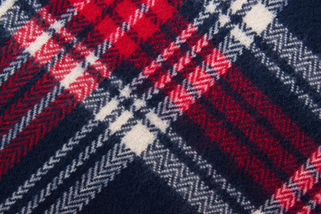 Blue, white, red cage texture fabric. Winter cashmere scarf. Textile warm dark knitted cloth background.の写真素材