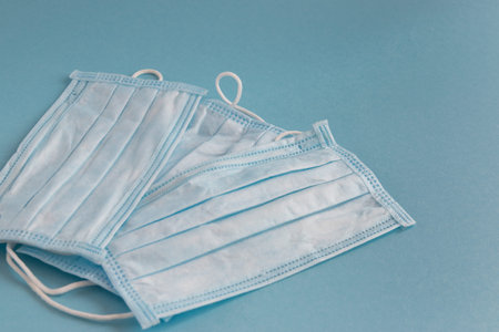 Medical mask for face on the blue background. Antibacterial, against pollution or virus protection....