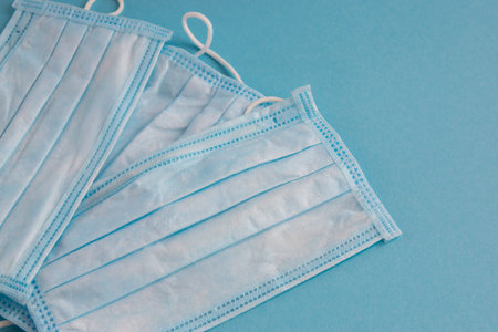 Medical mask for face on the blue background. Antibacterial, against pollution or virus protection....