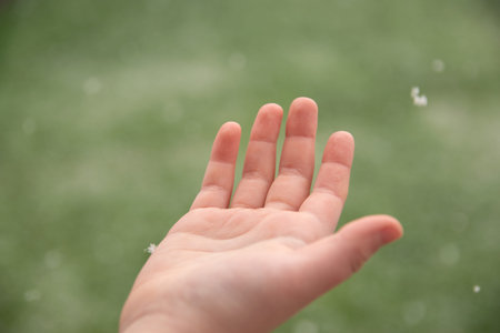 Helthy skin. Close-up of beautiful hand on green natural background.