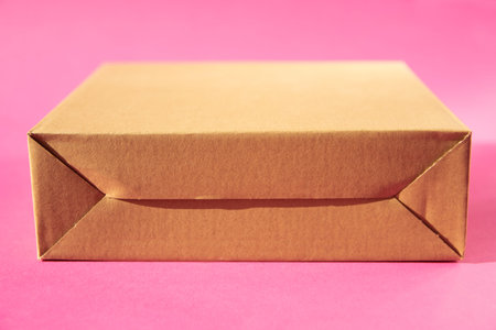 Eco cardboard box on pink background. Mockup for design.