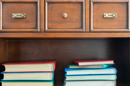 Small collection of different books on shelves in home library.の写真素材