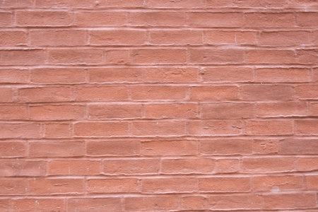 Red structural stone wall of the ancient building consists of old bricks. Nature structural...