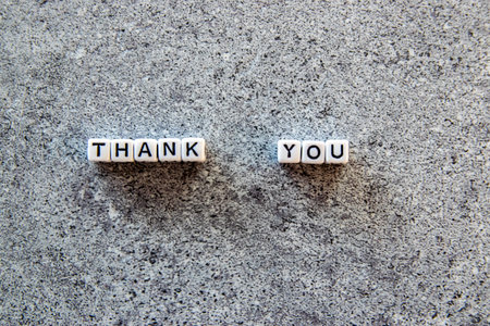 Thank you exclamation word on the stone background.の写真素材