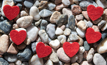 Red bright fabric hearts on other stones near the river.の写真素材