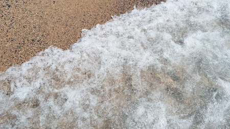 Clear transparent sea water and meershaum in sunny day with much sand.