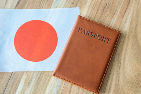 Passport on the Japan flag background. Travel, business or emigration.の写真素材