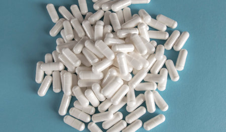 Much medical yellow pills and drugs in transparent package on the blue paper background. Healthcare concept.の写真素材