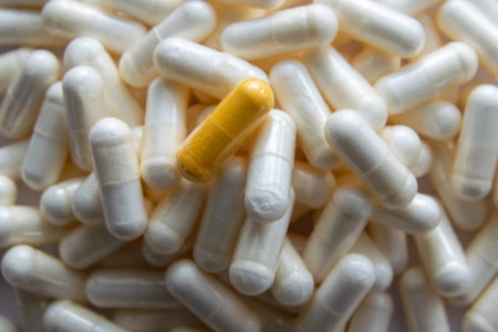 Much medical white pills and drugs in transparent package on the black stone background. Healthcare...