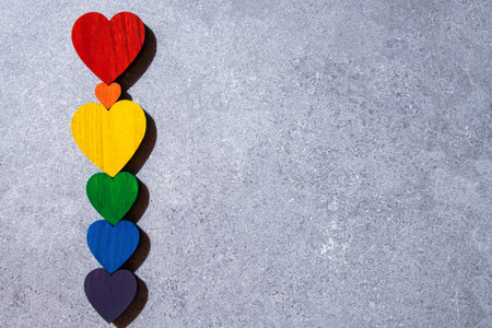Rainbow colors wood hearts on the stone black background. LGBT flag.の写真素材