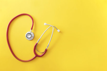 Stethoscope on the yellow paper background with space for text. Medical instrument. Health care concept.の写真素材