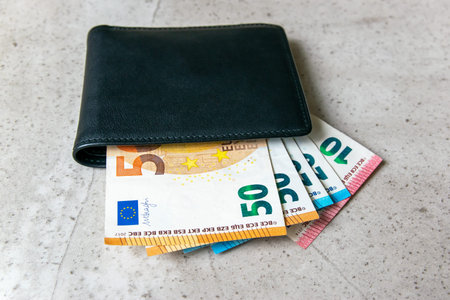 Black partmone with euro money. Paper bills in leather wallet for commerce concept.