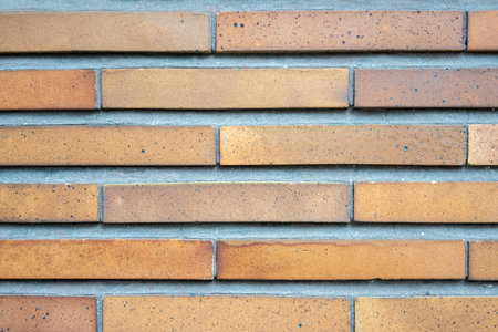 Brown structural stone wall of the ancient building consists of bricks. Nature structural...