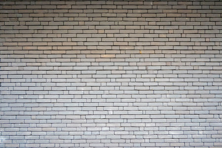 Gray structural stone wall of the ancient building consists of bricks. Nature structural background.の写真素材