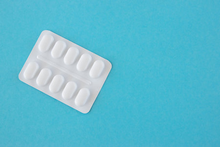 Much medical pills and drugs in white plastic package on the blue background. Healthcare concept...