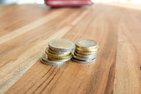 Coins stack on the wood table.