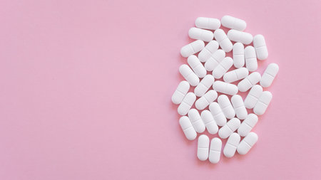 Much medical tablets on the pink background. Healthcare concept. Space for text.