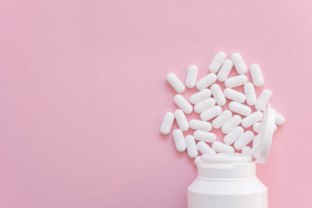 Much medical pills and drugs in white package on the pink background. Healthcare concept. Space for text.の写真素材