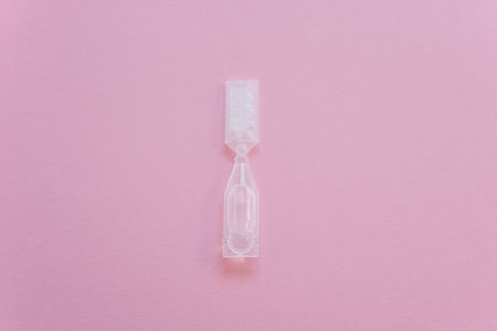 Eye drops in small disposable plastic multidose ampoule. Space for text.の写真素材