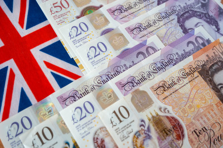 England national flag and british pound money. United Kindom paper bills for commerce concept.の写真素材