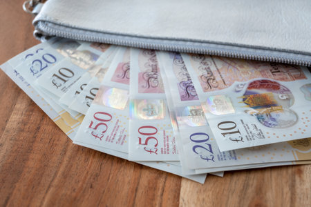 Silver partmone with British pound money. United Kingdom bills in leather wallet for commerce concept.の写真素材
