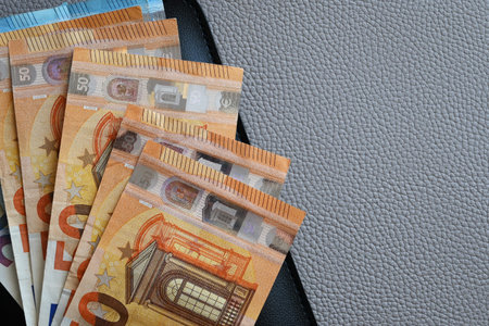 Black partmone with euro money. Paper bills in leather wallet for commerce concept.の写真素材