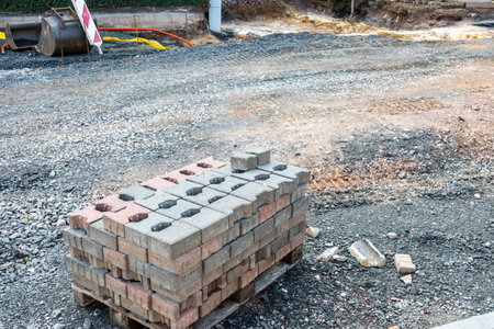 Pavement tiles in stack for road sidewalk repair. Construction process and urban infrastructure in...